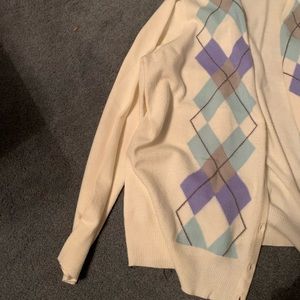 The color in the cardigan are purple grey white and blue